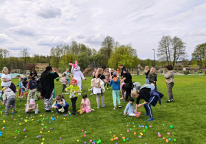 Dzieci zbierają plastikowe jaja z trawy