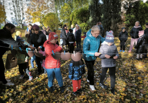 Dzieci zawieszają do sznurka za pomocą klamerki kształt jabłka