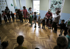 Dzieci stoją w kole i trzymają się za ręce
