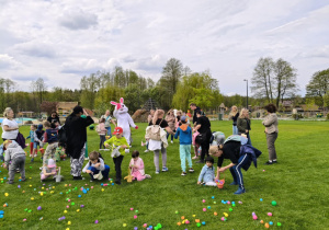 Dzieci zbierają plastikowe jaja z trawy